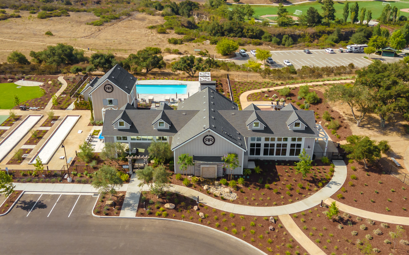 An aerial view of a large house and golf course.