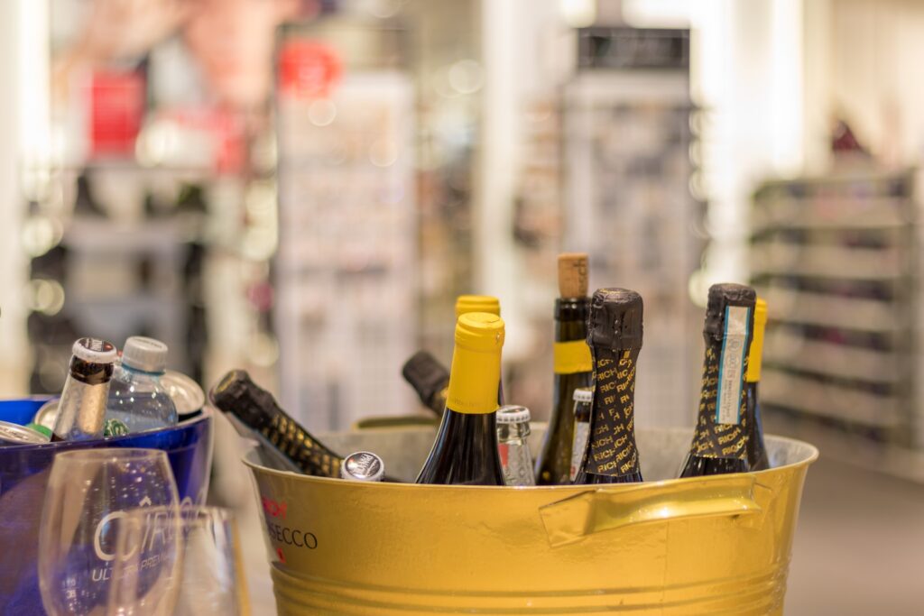 shallow focus photo of bottles on yellow steel bucket. Wine Harvest